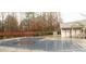 Community pool with a safety cover and bath house in a wooded setting, perfect for summer fun at 119 Snead Rd, Fort Mill, SC 29715