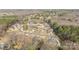 Aerial view of homes nestled in a suburban neighborhood near a wooded area, featuring landscaped yards at 12515 Hashanli Pl, Matthews, NC 28105