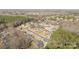 An aerial view shows lush tree canopy surrounding suburban homes in this residential area at 12515 Hashanli Pl, Matthews, NC 28105