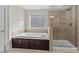Bathroom featuring a soaking tub, separate shower, and tiled walls at 12515 Hashanli Pl, Matthews, NC 28105