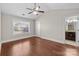 Bright bedroom featuring hardwood floors, ceiling fan, and ensuite bathroom at 12515 Hashanli Pl, Matthews, NC 28105