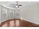 Bedroom featuring hardwood floors, natural light, and a tray ceiling at 12515 Hashanli Pl, Matthews, NC 28105
