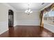 Bright dining room with hardwood floors, stylish chandelier, and stainless steel appliances nearby at 12515 Hashanli Pl, Matthews, NC 28105