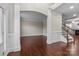 Inviting foyer showcasing hardwood floors, an open archway, staircase, and elegant trim work at 12515 Hashanli Pl, Matthews, NC 28105