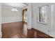 Elegant foyer featuring hardwood floors, decorative molding, and a stylish chandelier at 12515 Hashanli Pl, Matthews, NC 28105