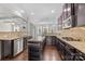 Gourmet kitchen with stainless steel appliances, granite countertops, and dark wood cabinetry at 12515 Hashanli Pl, Matthews, NC 28105