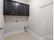 Laundry room with storage cabinets and tile floors at 12515 Hashanli Pl, Matthews, NC 28105