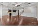 Bright living room with hardwood floors, coffered ceiling, and an open floor plan at 12515 Hashanli Pl, Matthews, NC 28105