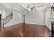 Open-concept space with staircase, hardwood floors, and bright natural light at 12515 Hashanli Pl, Matthews, NC 28105