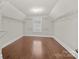 Walk-in closet with custom shelving and hardwood floors at 12515 Hashanli Pl, Matthews, NC 28105