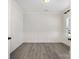 Empty office space with gray flooring, wainscoting, and natural light from a window at 1308 Stone Marker Dr, Monroe, NC 28112