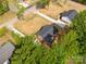 High-angle view of a property featuring a driveway, tree coverage, and surrounding landscaping at 1323 Mack Dr, McConnells, SC 29726