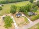 Overhead shot showcases three residential homes with long driveways, spacious lawns, and mature trees at 1323 Mack Dr, McConnells, SC 29726