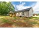 Back of a single-story home featuring a spacious yard and wooden porch area at 1323 Mack Dr, McConnells, SC 29726