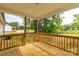 Inviting back porch with wooden railing offering scenic views of the surrounding greenery at 1323 Mack Dr, McConnells, SC 29726