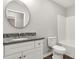 Bathroom featuring a granite countertop, round mirror, and bathtub with white tile surround at 1323 Mack Dr, McConnells, SC 29726