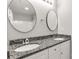 Bathroom featuring double sinks, granite countertops, and round mirrors at 1323 Mack Dr, McConnells, SC 29726