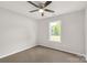 Neutral bedroom with a large window showing exterior views and a ceiling fan at 1323 Mack Dr, McConnells, SC 29726