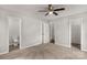 A neutral bedroom with a ceiling fan, three doorways, and carpeted floors at 1323 Mack Dr, McConnells, SC 29726