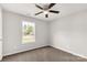 Neutral bedroom with a large window showing exterior views and a ceiling fan at 1323 Mack Dr, McConnells, SC 29726