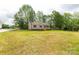 A charming single-story home surrounded by trees and an expansive lawn at 1323 Mack Dr, McConnells, SC 29726