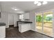 Well-lit kitchen featuring granite countertops, stainless steel appliances, and access to the back porch at 1323 Mack Dr, McConnells, SC 29726