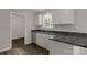Bright kitchen with granite countertops, stainless steel dishwasher, and white cabinetry at 1323 Mack Dr, McConnells, SC 29726