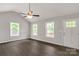 Sunlit living room featuring neutral walls, ceiling fan, and multiple windows at 1323 Mack Dr, McConnells, SC 29726