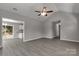 Living room with gray walls, hardwood flooring, ceiling fan and open access to kitchen at 1323 Mack Dr, McConnells, SC 29726