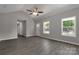 Living room with gray walls, hardwood flooring, ceiling fan and natural light from two windows at 1323 Mack Dr, McConnells, SC 29726