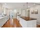 Spacious white kitchen with stainless steel appliances, granite countertops, and a center island with bar seating at 138 Lansdowne Rd, Charlotte, NC 28270