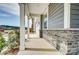 Inviting covered front porch with stone accents and natural light at 1471 Honey Trl, Monroe, NC 28112