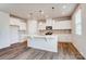 Bright kitchen with white cabinetry, center island, and pendant lighting at 1471 Honey Trl, Monroe, NC 28112