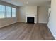 Bright living room with hardwood floors, a modern fireplace, and large windows at 1471 Honey Trl, Monroe, NC 28112