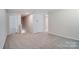 Spacious loft area featuring neutral carpeting, ample natural light, and versatile layout options for relaxation or entertainment at 1471 Honey Trl, Monroe, NC 28112