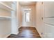 Bright entryway with hardwood floors, white shelves, and a glass-paneled front door at 14730 Tamarack Dr, Charlotte, NC 28278