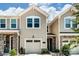 Charming townhouse with stone accents, two-car garage, and well-maintained landscaping at 14730 Tamarack Dr, Charlotte, NC 28278