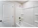 Bathroom featuring a shower-tub combination with white tile surround at 14734 Tamarack Dr, Charlotte, NC 28278