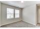 Bright bedroom with two windows and neutral carpet at 14734 Tamarack Dr, Charlotte, NC 28278