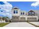 Beautiful townhome featuring stone accents, modern garage doors, and manicured landscaping at 14734 Tamarack Dr, Charlotte, NC 28278