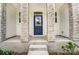 Inviting front entrance with stylish stone pillars and a classic blue door at 14734 Tamarack Dr, Charlotte, NC 28278