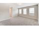 Inviting living room featuring neutral walls, plush carpeting, and bright windows at 14734 Tamarack Dr, Charlotte, NC 28278