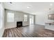 Open living space with fireplace, hardwood floors, recessed lighting and sliding glass doors to the yard at 14734 Tamarack Dr, Charlotte, NC 28278