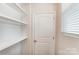 Functional pantry space with white shelves and a convenient door at 14734 Tamarack Dr, Charlotte, NC 28278