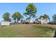 Expansive backyard featuring a storage shed, mature trees, well-manicured lawn, and privacy fence at 152 Painted Bunting Dr, Troutman, NC 28166