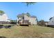 Spacious backyard featuring a well-maintained lawn, deck, patio, and privacy fence at 152 Painted Bunting Dr, Troutman, NC 28166