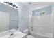 Clean bathroom with a single vanity, tub-shower combo with white tile and a large mirror at 152 Painted Bunting Dr, Troutman, NC 28166