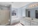 Bright bathroom with double vanity, shower, bath tub, and neutral colors at 152 Painted Bunting Dr, Troutman, NC 28166