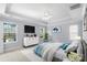 A spacious bedroom with a trey ceiling, TV, large windows, and a ceiling fan at 152 Painted Bunting Dr, Troutman, NC 28166