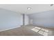 Neutral bedroom features light blue walls, beige carpeting, closet, and recessed lighting at 152 Painted Bunting Dr, Troutman, NC 28166